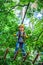 Happy Little child climbing a tree. Early childhood development. Adventure climbing high wire park. Child boy having fun