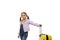 Happy little child girl in purple denim jacket, posing with yellow suitcase over white background with copy space for ad