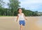 Happy little child girl running on the beach in summer times