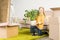 happy little child holding houseplant and smiling at camera while moving home