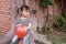 Happy little cute lovely girl Chinese child smile laugh play red balloon have fun at summer park nature happiness childhood