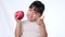 Happy little girl with apple. Cute Asian little girl eating organic apple on white background in studio. Healthy nutrition for sma