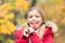 Happy little girl in autumn forest. Feeling protected at this autumn day. Small child with autumn leaves. Little girl