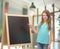 Happy little girl with blackboard and chalk