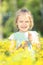 Happy little girl on blooming meadow