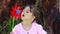 Happy little girl blowing on a pinwheel