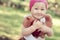 Happy little girl in cap playing with Teddy bear