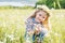 Happy little girl in the chamomile field