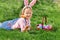 Happy little girl child hunting Easter eggs in the garden