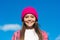 Happy little girl child wear pink hat on long hair in casual fashion style smiling on sunny blue sky, childhood