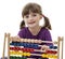 Happy little girl counting with abacus