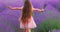 Happy little girl with dress enjoying lavender field with bouquet of flowers