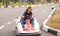 Happy little girl driving kart in park