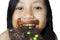 Happy little girl eating chocolate bar on studio