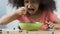 Happy little girl eating delicious breakfast cereal in slow-mo, chocolate puffs