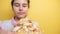 Happy little girl eating a slice of pizza concept. teenager child hungry eats a slice of pizza. slow motion video. pizza