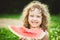 Happy little girl eating watermelon in summer park. Instagram filter.