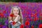 Happy little girl in a field of poppies