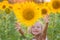 Happy little girl in the field of sunflowers