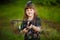 Happy little girl help parents in garden with rake