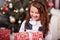 Happy little girl holding a Christmas present