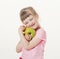 Happy little girl holding a green apple