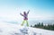 Happy little girl jumping on the deep snow hill with a great over city view