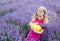 Happy little girl is in a lavender field