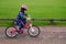 Happy little girl learns how to ride a bike