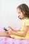 Happy little girl lying on bed with tablet computer