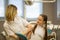 Happy little girl patient and woman dentist, together portrait in dental room.