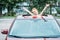 happy little girl peering out of car