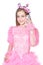 Happy little girl in pink carnival costume talking on phone