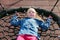 Happy little girl playing on a swing and having fun at kids modern playground