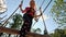 Happy Little Girl Playing in Tarzan Attraction on Playground in Amusement Park