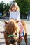Happy little girl on a pony