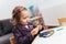 Happy little girl, preschooler, painting with water color, selective focus