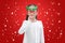 Happy little girl reindeer with floating snow on red christmas background