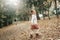 Happy little girl running in autumn park. Cheerful kid enjoying in forest outdoor. Childhood lifestyle nature concepts