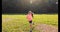 Happy little girl running or jogging in the park