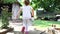 Happy little girl running with strawberry basket in garden. Home-grown fruits and vegetables in the countryside