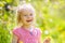 Happy little girl in spring sunny park