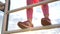 Happy little girl in a stylish baseball cap climbs up the stairs at sunset