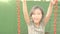 Happy little girl swinging on a swing outdoor