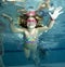 Happy little girl underwater in pool