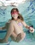 Happy little girl underwater in pool