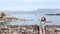 Happy little girl waving with Greek flag in Corfu town