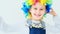 Happy little girl wearing rainbow wig