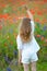 Happy little girl wearing white dress lift hand at the nature. B