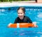 Happy little girl in a wetsuit